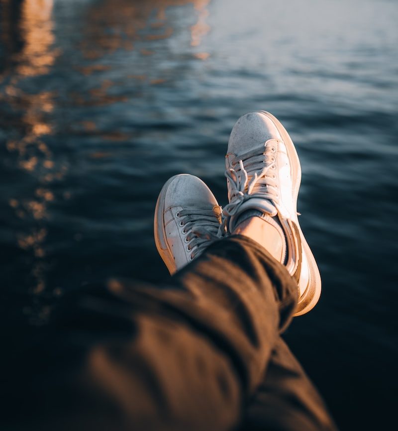 Photo by Musa Ortaç a person's feet sticking out of the water